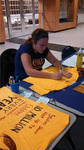 Fall 2013 Clothesline Project Shirt Decorating [Photo 6] by University of Northern Iowa. Women's and Gender Studies.
