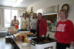 Volunteers serving food at St. Bridget's Catholic Church by Julie Berg-Raymond