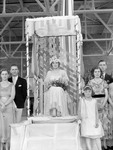 May Queen Sitting Before a Crowd