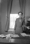 Woman Standing Behind a Desk