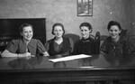 Four Women Sitting at Table 01