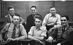 Six Men Posing at Desks